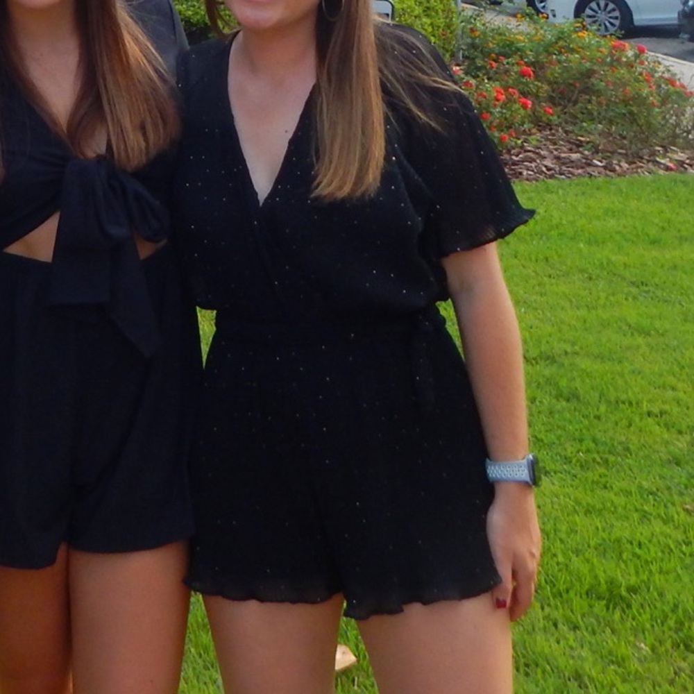 Black romper with gold beads.